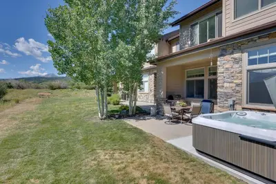 a house with a hot tub in the yard at Stunning Mtn Views and Hot Tub Silverthorne Retreat in Silverthorne