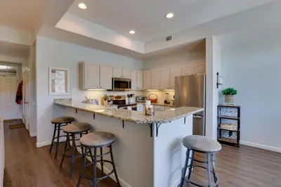 a kitchen with a large island with bar stools at Stunning Mtn Views and Hot Tub Silverthorne Retreat in Silverthorne
