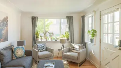 a living room with a couch and chairs and a window at Comfy w King Bed Bring pup & walk 2 Everything in Arvada