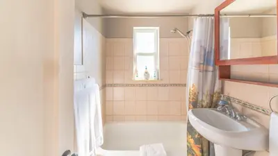 a bathroom with a sink and a bath tub at Comfy w King Bed Bring pup & walk 2 Everything in Arvada