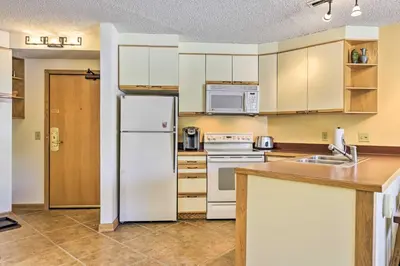 a kitchen with white appliances and a white refrigerator at Cozy Ski-InandSki-Out Winter Park Resort Condo! in Winter Park