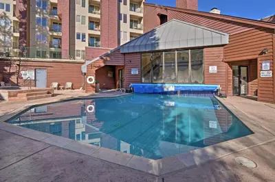 a swimming pool in the middle of a building at Cozy Ski-InandSki-Out Winter Park Resort Condo! in Winter Park