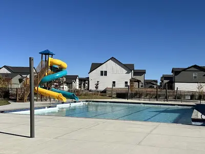 a swimming pool with a yellow inflatable slide at Modern & Stunning Home near Breweries and Old Town in Fort Collins