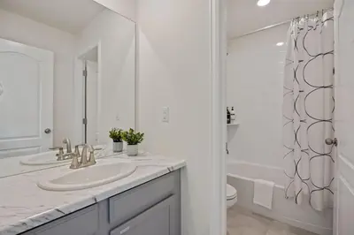 a white bathroom with a sink and a shower at Modern & Stunning Home near Breweries and Old Town in Fort Collins