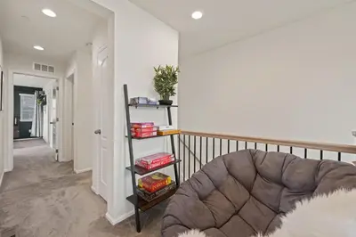 a living room with a couch and a book shelf at Modern & Stunning Home near Breweries and Old Town in Fort Collins