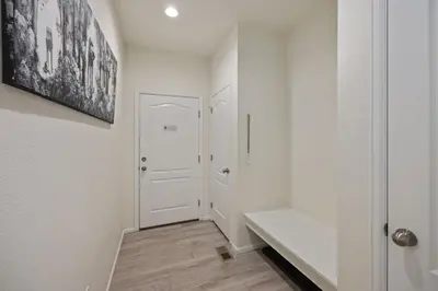 a hallway with white walls and a white door at Modern & Stunning Home near Breweries and Old Town in Fort Collins