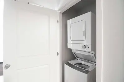 a room with a washing machine and a microwave at Relaxing 3BR Apartment With Pool & Wifi in Greeley
