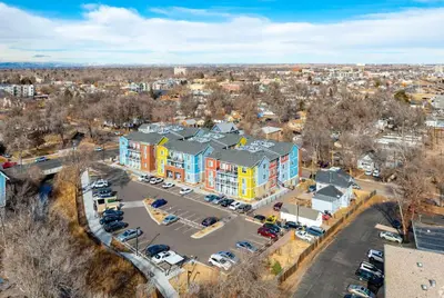 an aerial view of a building with a parking lot at Relaxing 3BR Apartment With Pool & Wifi in Greeley