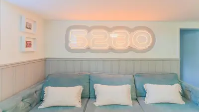 a blue couch with two white pillows in a room at Sloans Lake Walk to eateries bars Free parking in Denver