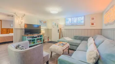 a living room with a couch and a tv at Sloans Lake Walk to eateries bars Free parking in Denver