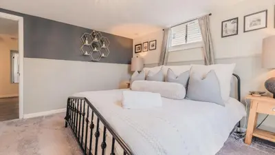 a bedroom with a large white bed and a window at Sloans Lake Walk to eateries bars Free parking in Denver