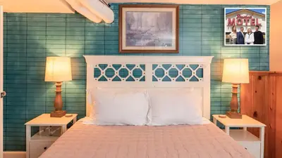 a bedroom with a bed with two tables and two lamps at Sloans Lake Walk to eateries bars Free parking in Denver