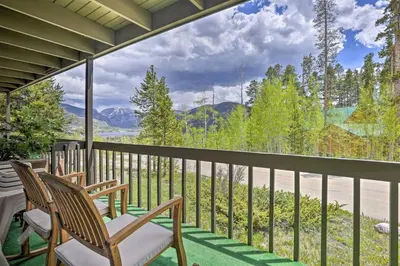 a balcony with chairs and a view of the mountains at Grand Lake Condo with Mountain Views Walk to Lake! in Grand Lake