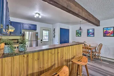 a kitchen with a wooden counter top and a table at Grand Lake Condo with Mountain Views Walk to Lake! in Grand Lake