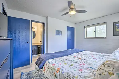 a bedroom with a bed and a ceiling fan at Grand Lake Condo with Mountain Views Walk to Lake! in Grand Lake