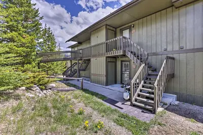 a house with stairs leading up to a building at Grand Lake Condo with Mountain Views Walk to Lake! in Grand Lake