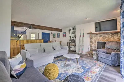 a living room with a couch and a fireplace at Grand Lake Condo with Mountain Views Walk to Lake! in Grand Lake