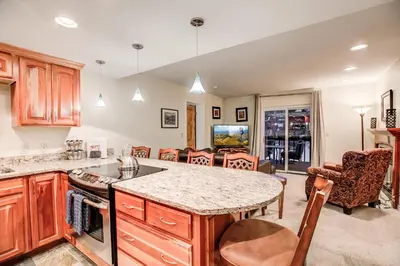 a kitchen with a table and a dining room at Mountainside Pineview Condo: Cozy Frisco Retreat in Frisco