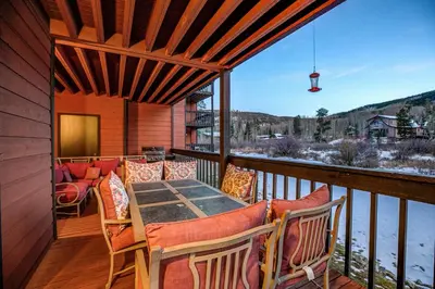 a patio with a table and chairs on a balcony at Mountainside Pineview Condo: Cozy Frisco Retreat in Frisco