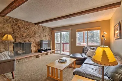 a living room with a couch and a fireplace at Idyllic Condo about 5 Mi to Winter Park Resort! in Winter Park