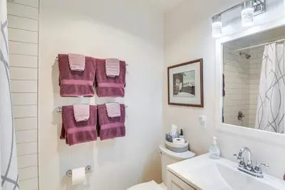 a bathroom with purple towels and a sink at Idyllic Condo about 5 Mi to Winter Park Resort! in Winter Park