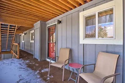 a porch with two chairs and a window at Idyllic Condo about 5 Mi to Winter Park Resort! in Winter Park