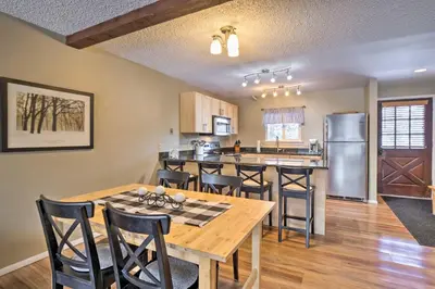 a kitchen and dining room with a table and chairs at Idyllic Condo about 5 Mi to Winter Park Resort! in Winter Park