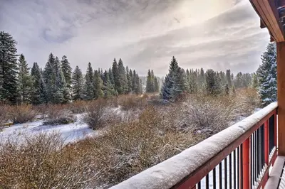 a winter view of a snow covered forest with a fence at Idyllic Condo about 5 Mi to Winter Park Resort! in Winter Park