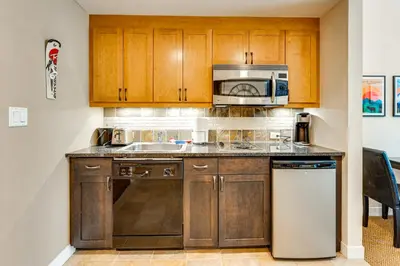 a kitchen with a sink and a microwave at Ski-InandSki-Out Winter Park Condo with Balcony in Winter Park