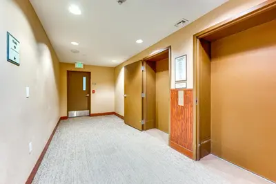 an empty hallway with doors and a carpet at Ski-InandSki-Out Winter Park Condo with Balcony in Winter Park