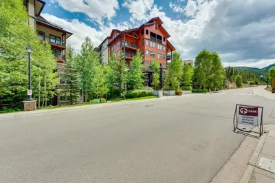 an empty street with a no parking sign in front of a building at Ski-InandSki-Out Winter Park Condo with Balcony in Winter Park