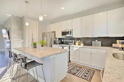 a kitchen with white cabinets and a counter top at Private Balcony Pet-Friendly Denver Escape! in Denver