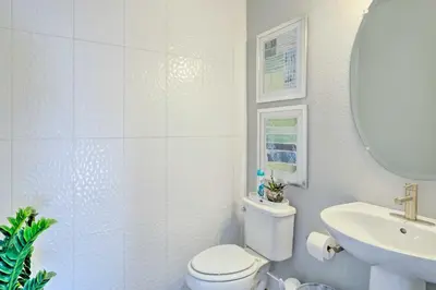 a bathroom with a toilet and a sink and a mirror at Private Balcony Pet-Friendly Denver Escape! in Denver