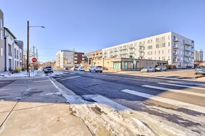 an empty street in a city with buildings and a stop sign at Private Balcony Pet-Friendly Denver Escape! in Denver