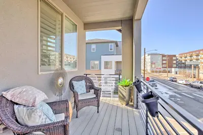 a balcony with wicker chairs and a view of a street at Private Balcony Pet-Friendly Denver Escape! in Denver