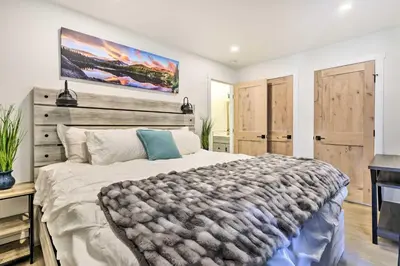 a bedroom with a large bed with a wooden headboard at Chic Condo with Fireplace Walk to Main St Frisco! in Frisco