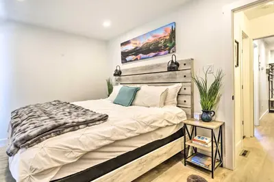 a bedroom with a large bed with a wooden headboard at Chic Condo with Fireplace Walk to Main St Frisco! in Frisco