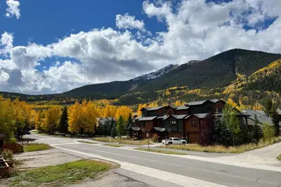a road with houses and mountains in the background at Chic Condo with Fireplace Walk to Main St Frisco! in Frisco