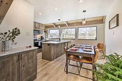 a kitchen and dining room with a table and chairs at Chic Condo with Fireplace Walk to Main St Frisco! in Frisco