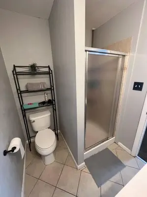 a small bathroom with a toilet and a shower at Modern Home Near Downtown in Denver
