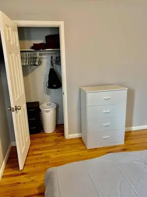 a bedroom with a bed and a dresser and a closet at Modern Home Near Downtown in Denver