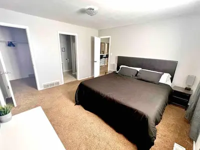 a bedroom with a large bed in a room at Modern Home Near Downtown in Denver