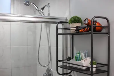 a black shelf in a bathroom with a shower at Well-Appointed Family Home in Aurora/Denver Colorado in Aurora