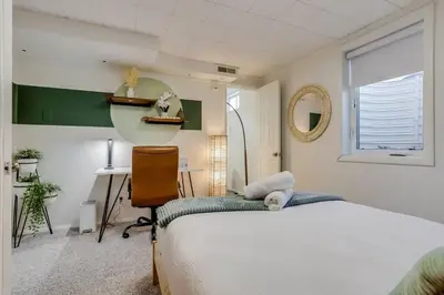 a bedroom with a bed and a desk and a mirror at Well-Appointed Family Home in Aurora/Denver Colorado in Aurora