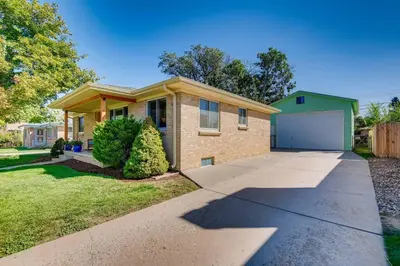 a house with a driveway and a garage at Well-Appointed Family Home in Aurora/Denver Colorado in Aurora