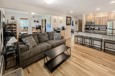 a living room with a couch and a kitchen at The Sanctuary Bldg 5 #7-8 in Winter Park