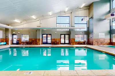 a swimming pool with blue water in a building at The Sanctuary Bldg 5 #7-8 in Winter Park