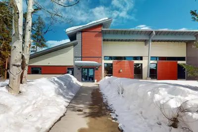 a building with a pile of snow in front of it at The Sanctuary Bldg 5 #7-8 in Winter Park