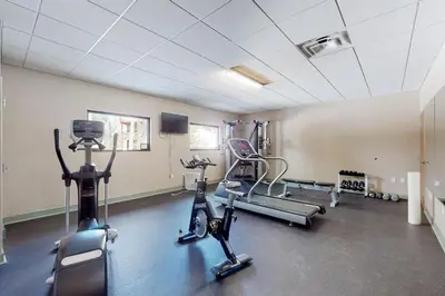 a gym with exercise bikes and tread machines in a room at The Sanctuary Bldg 5 #7-8 in Winter Park
