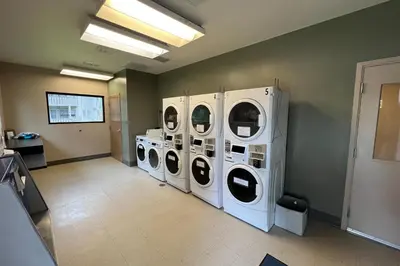 a laundry room with four washing machines in it at The Sanctuary Bldg 5 #7-8 in Winter Park